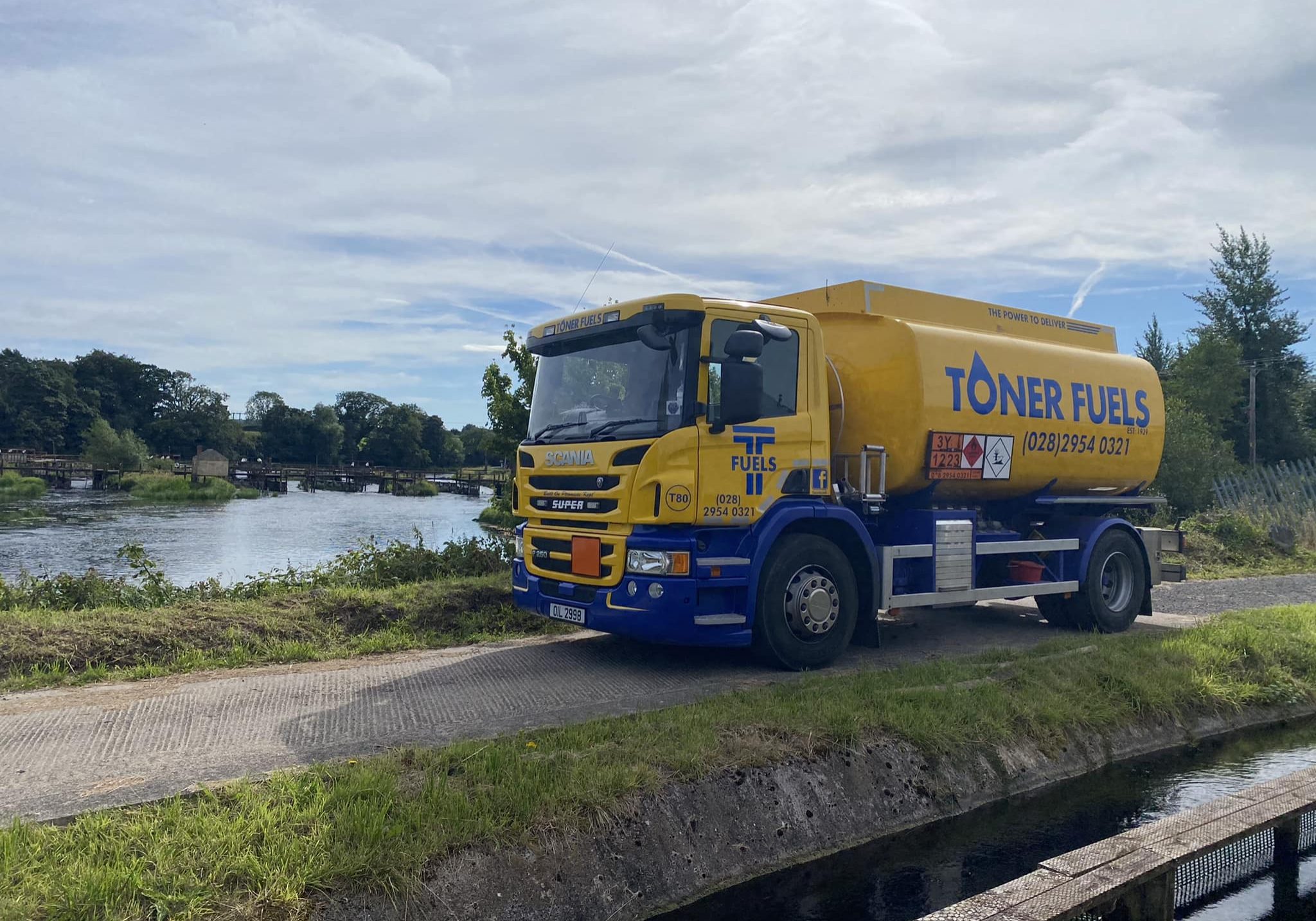Toner fuels truck at waterside of lake