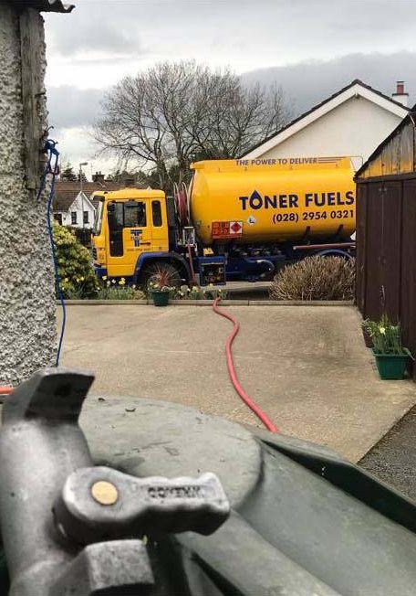 Toner fuels truck filling family oil tank